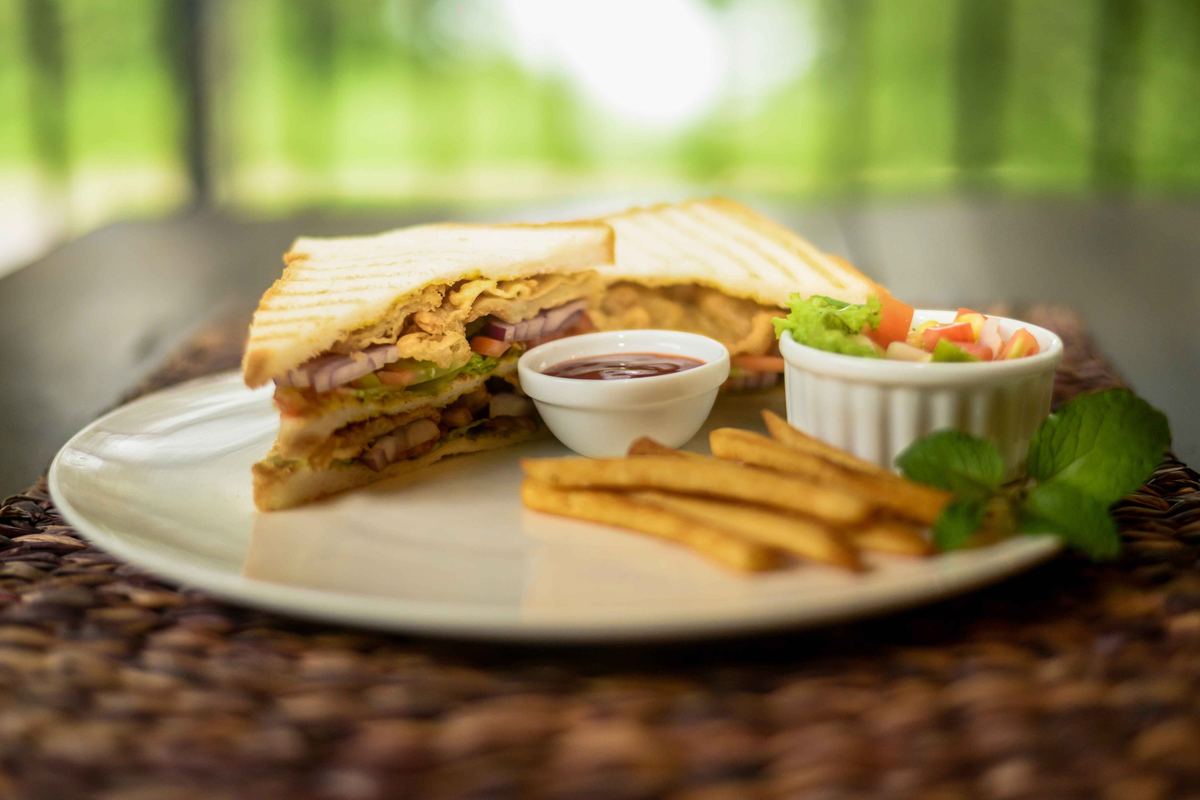 Grilled club sandwich with crispy fries and fresh salsa at Hambu Café