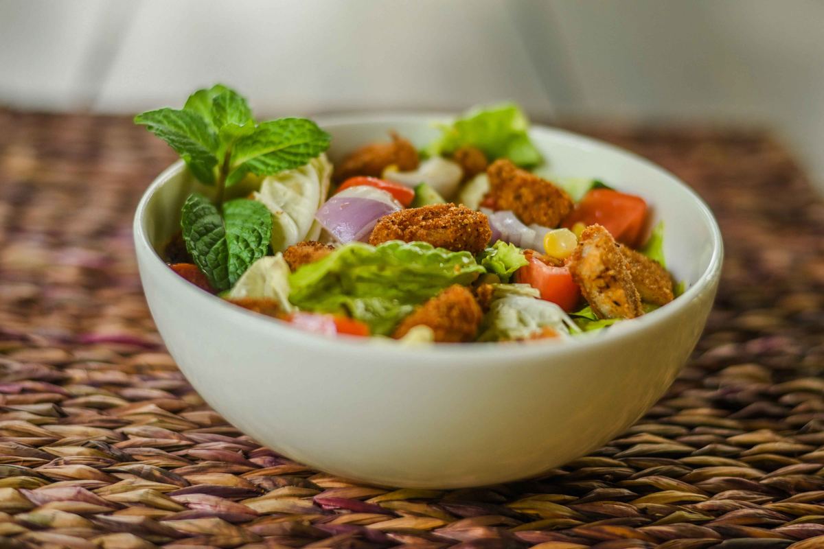 Fresh garden salad bowl with crumbed chicken and mint at Hambu Café