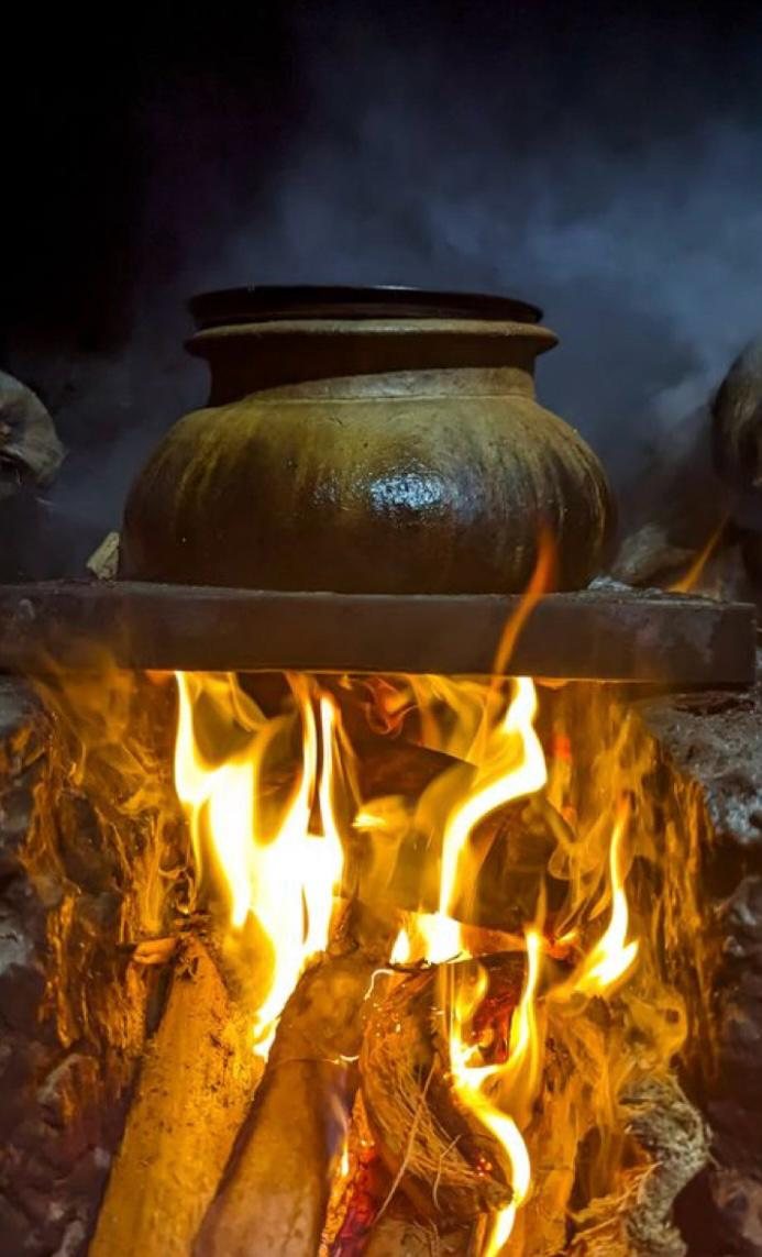 Traditional clay pot cooking over an open wood fire at Hambu Café