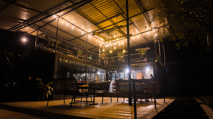 Hambu Café's exterior lit with string lights at night