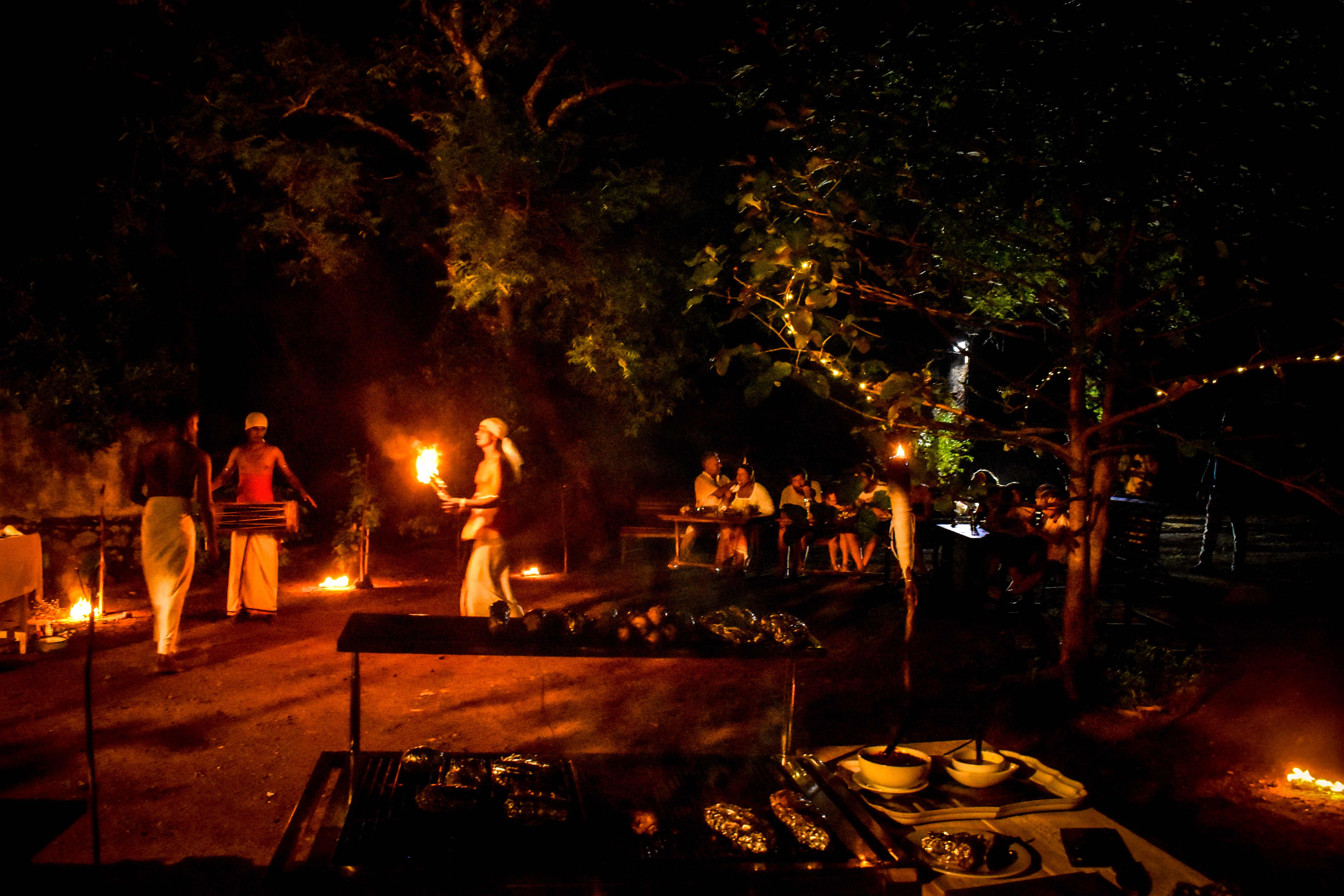 Traditional cultural performance with fire dancers and musicians