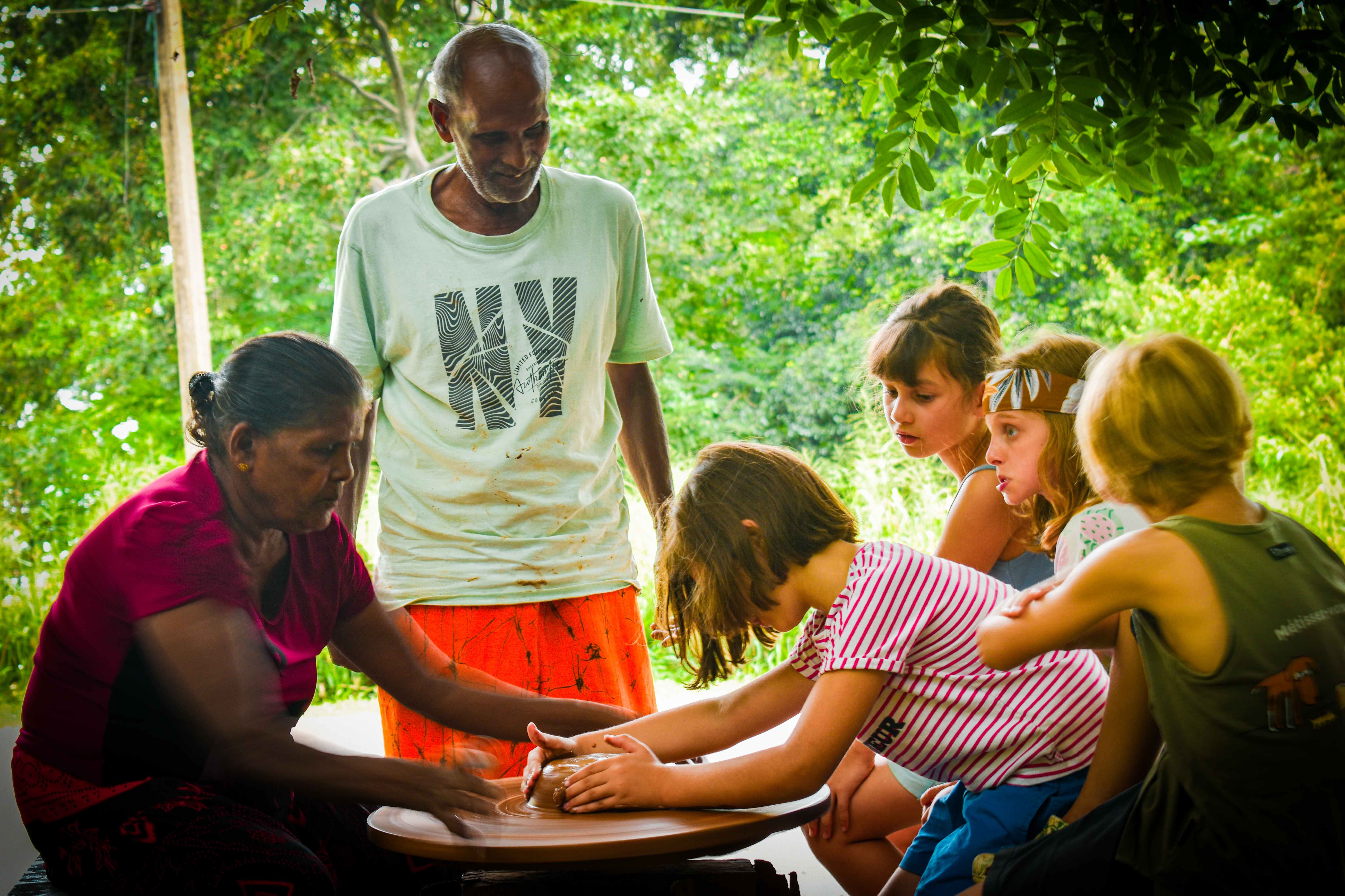 Children learning traditional pottery making